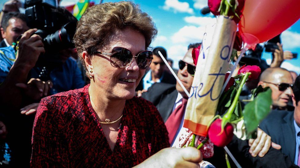 Dilma Rousseff receives flowers as she leaves Alvorada Palace in Brasilia. 6 Sept 2016