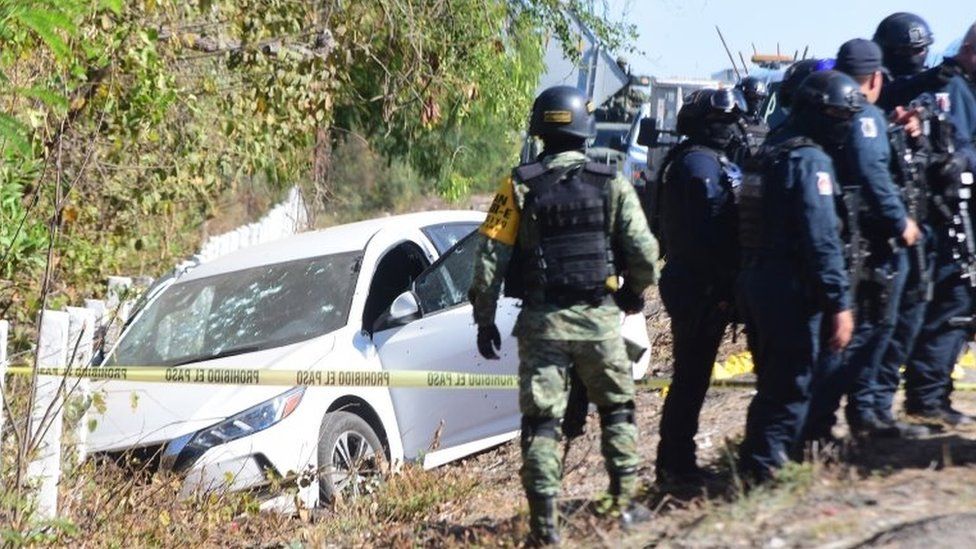 Soldiers of the National Guard and state policemen cordon off the vehicle in which the director of the Sinaloa State Preventive Police, Joel Ernesto Soto, was killed in Culiacan, Sinaloa state, Mexico, 24 May 2021.