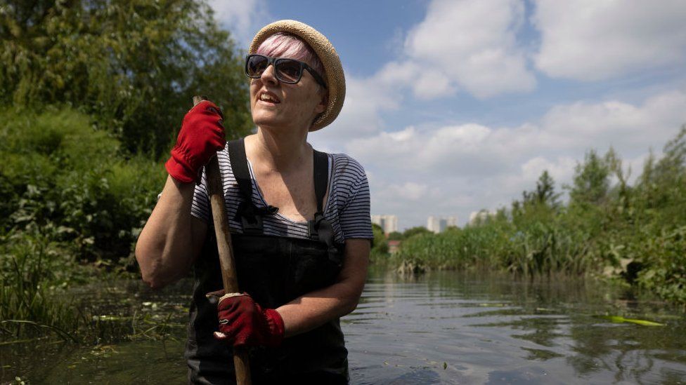 A volunteer taking part in a river cleanup in north London