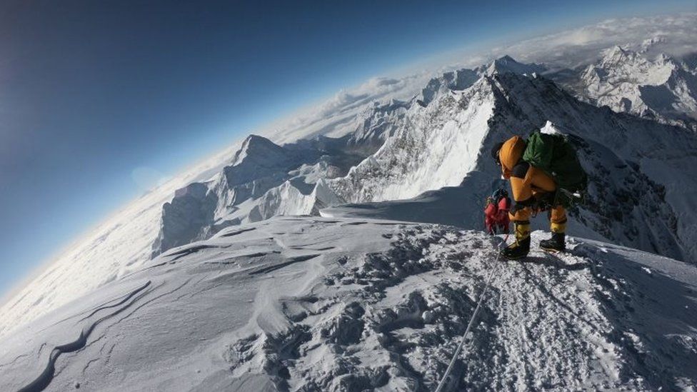 Mountaineers make their way to the summit of Mount Everest,