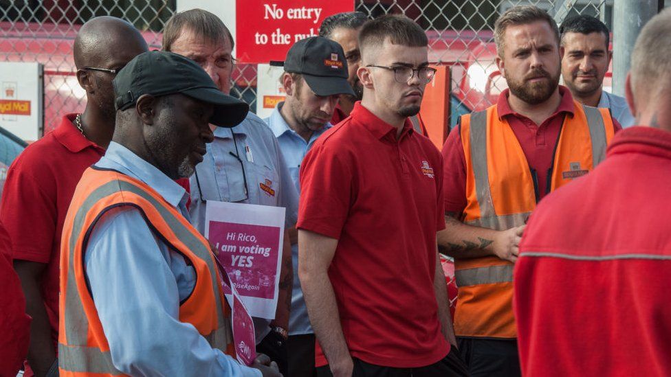 Workers listening to union rep