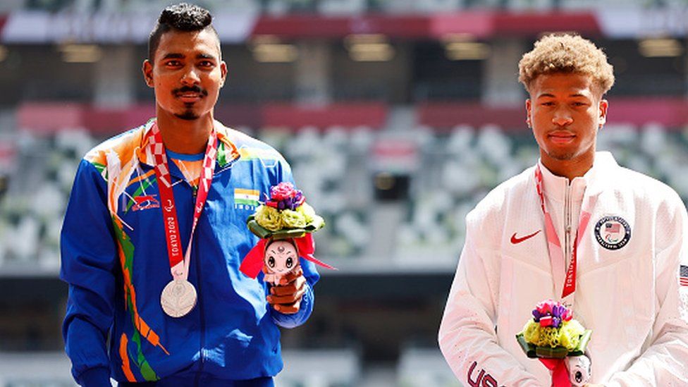 Silver medalists Nishad Kumar Nishad Kumar of Team India and Dallas Wise of Team United States pose during the men's High Jump - T47 medal ceremony