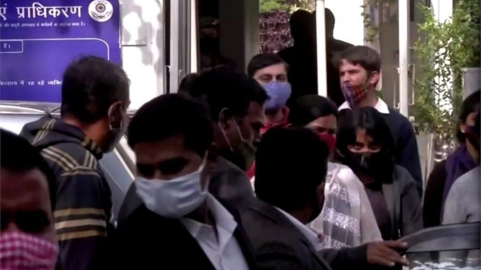 Climate change activist Disha Ravi is escorted by police officials as she walks out of the court in New Delhi, India February 14, 2021 in this still image taken from video.