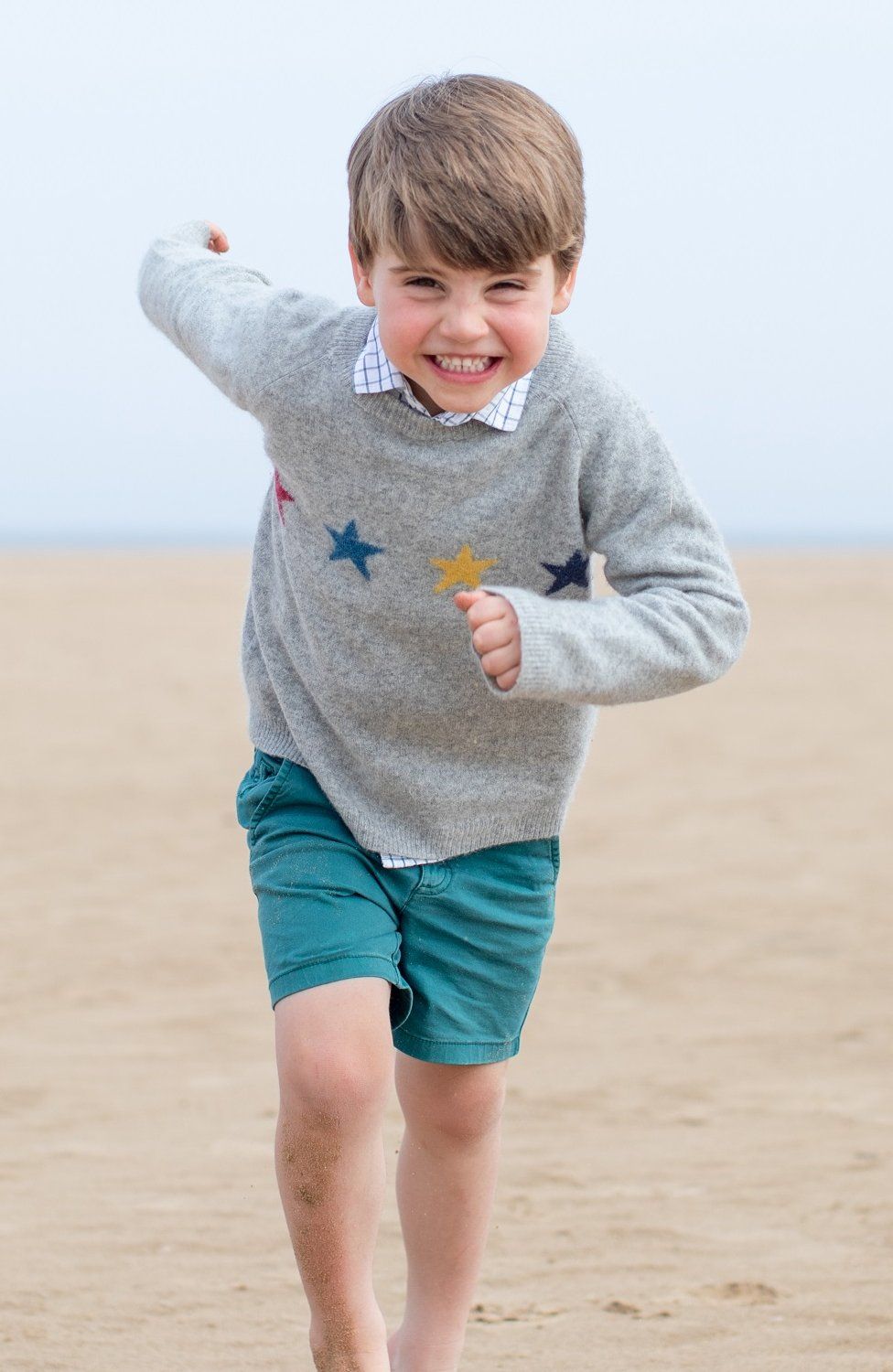 Prince Louis running on the beach