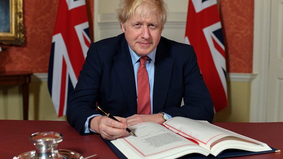 Boris Johnson signing Withdrawal Agreement
