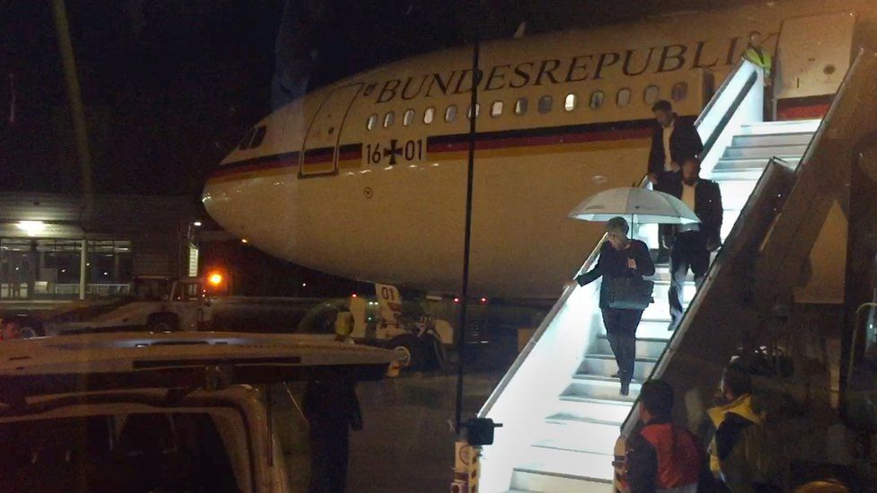 German Chancellor Angela Merkel steps down from Airbus "Konrad Adenauer" on late November 29, 2018 on the tarmac of Cologne"s airport after an emergency landing