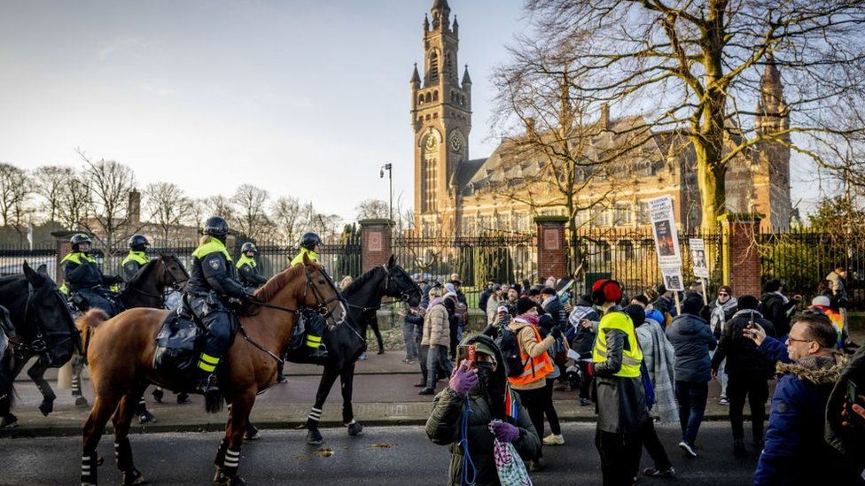 Police disperse protesters outside the ICJ in The Hague