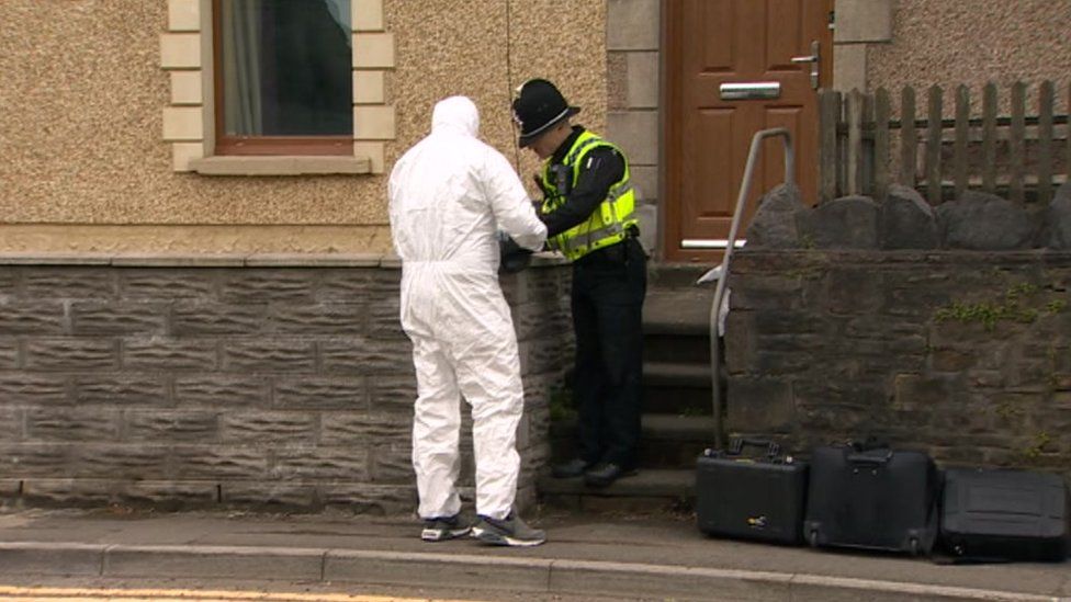 forensic and police officers at the house in Pentrechwyth Road, Swansea