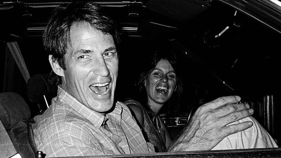 Actor John Bennett Perry and his wife, Debbie Perry, laugh together as they sit in their car circa 1987