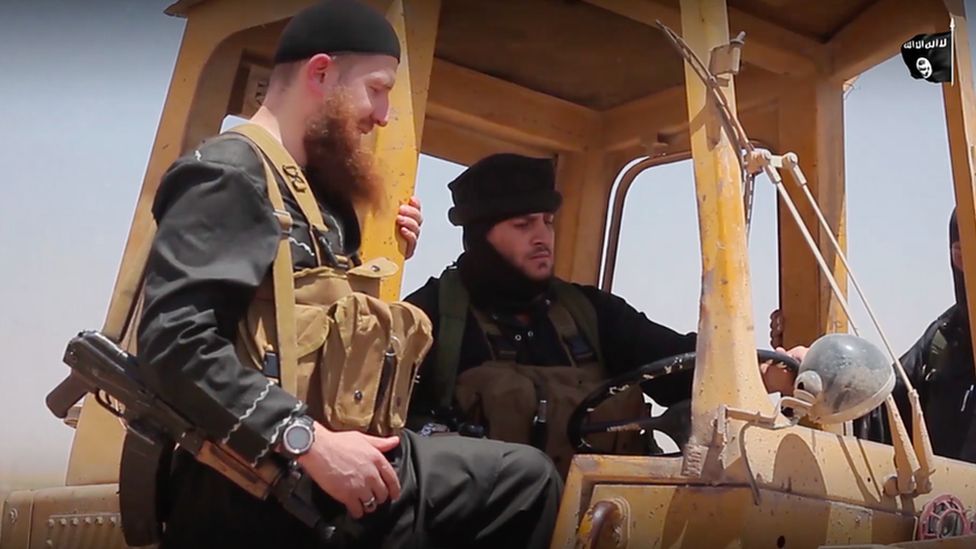 IS figures Abu-Muhammad al-Adnani and Omar Shishani shown bulldozing Iraq-Syria border