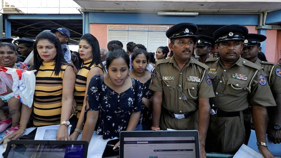 Twins wait in the line to register their names during an event to attempt to break the world record for the biggest gathering of twins in Colombo, Sri Lanka, on 20 January 2020