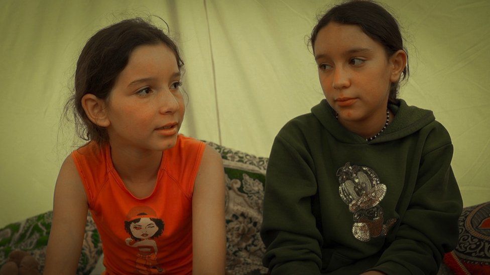 Doaa and Malak sit in a tent