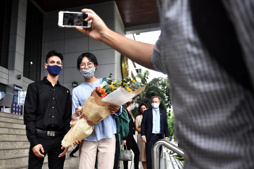 Thai human rights activist Sutharee Wannasiri (R) and Burmese migrant worker Nan Win leave the Criminal Court after being acquitted of criminal defamation charges by poultry giant Thammakaset Co. Ltd in Bangkok on June 8, 2020.