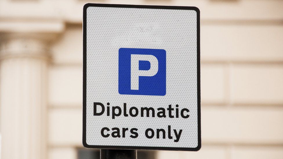 Parking sign saying "Diplomatic cars only"
