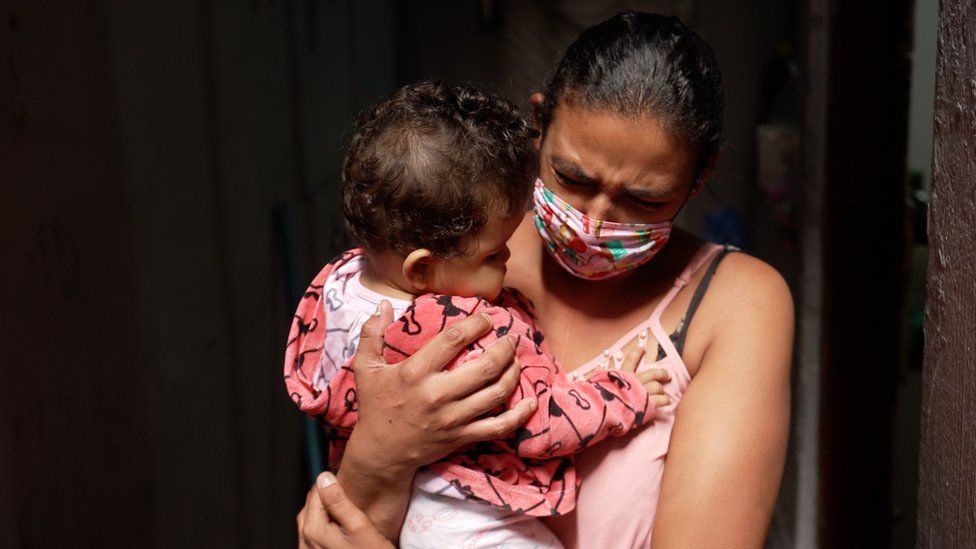 Luciana holding her nine-month-old daughter