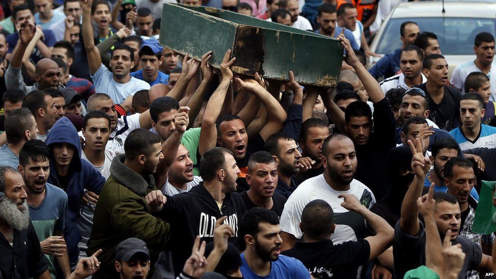 Palestinians carry body of Ahmad Qali, killed in clashes at the Shuafat refugee camp, 10 October 2015