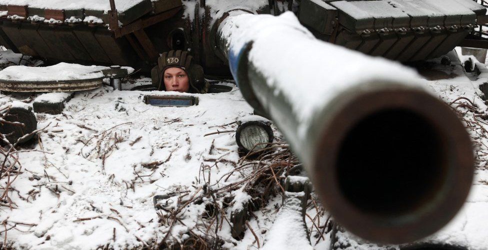 A Ukrainian soldier looks out from a tank near to the town of Bakhmut, Donetsk region