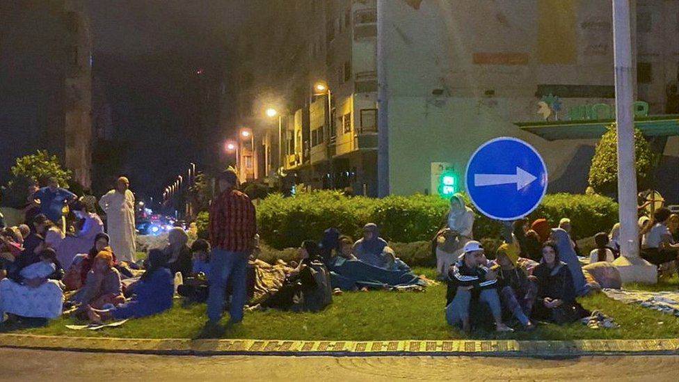 People sitting on roundabout in Casablanca at night, 9 Sep 23