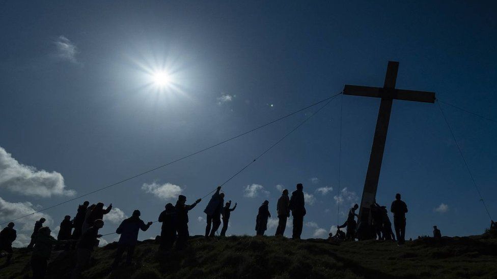 Christians erect a 30ft-high cross ahead of Easter on the top of Otley Chevin in West Yorkshire.