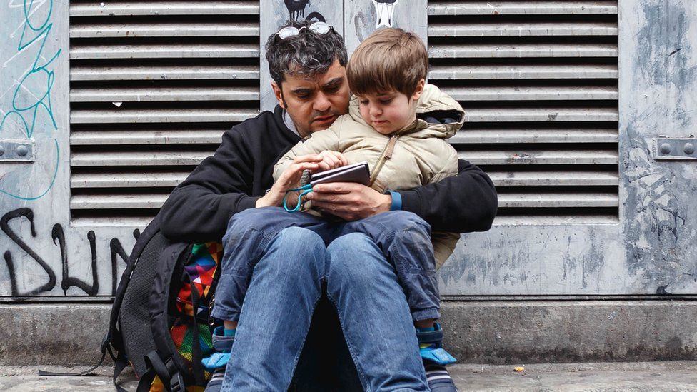 Man with son in lap