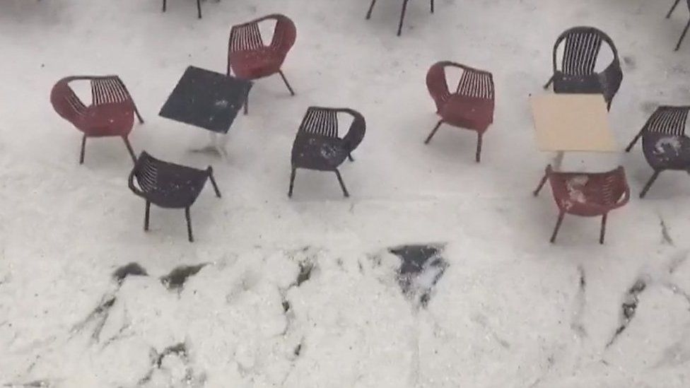 Icey water flows past cafe chairs