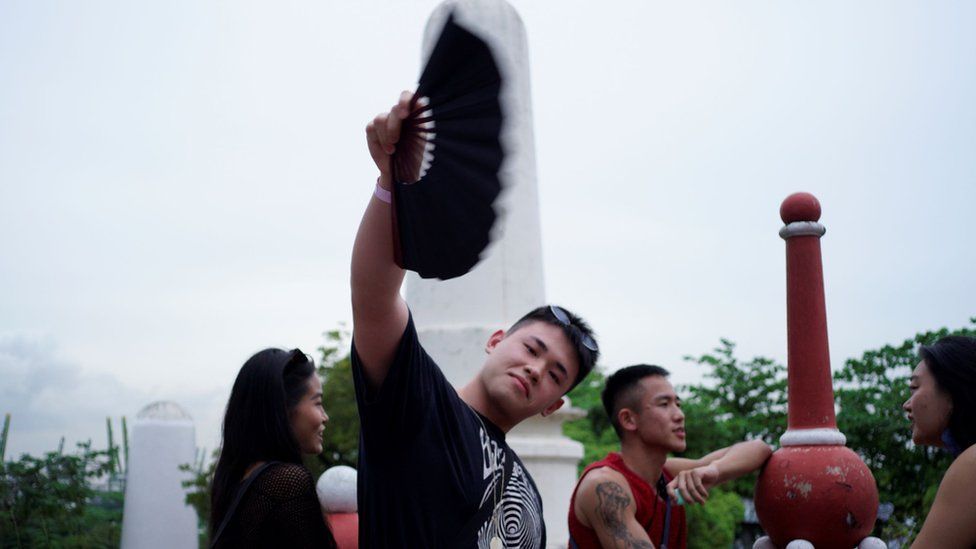 A rave-goer flashes a fan at the Haw Par Villa event on 13/11/22