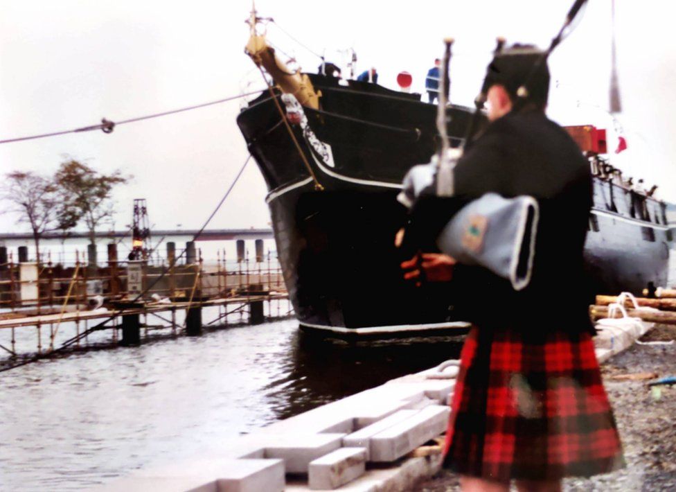 A piper welcomes the ship on its final voyage