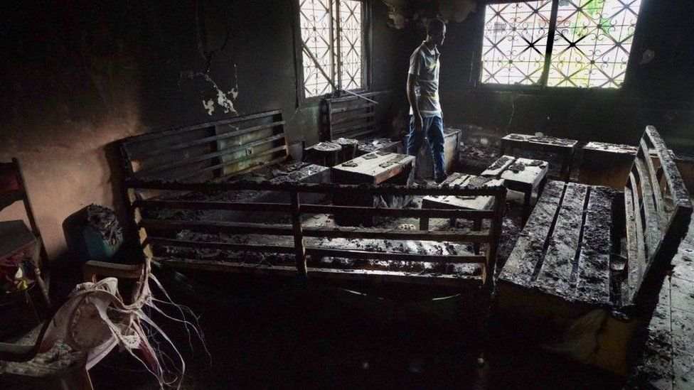 A local man walks thru a burnt-out restaurant on May 11, 2019 that was destroyed in fighting between armed Anglophone separatists and Cameroonian military forces in Buea,Cameroon