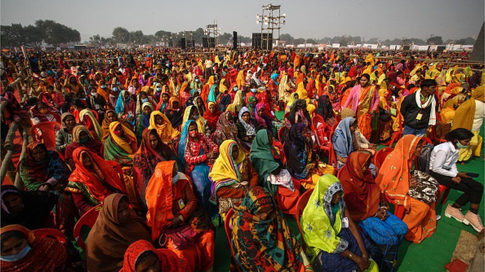 Women from various districts arrive to attend a rally held by India's Prime Minister Narendra Modi on December 21, 2021