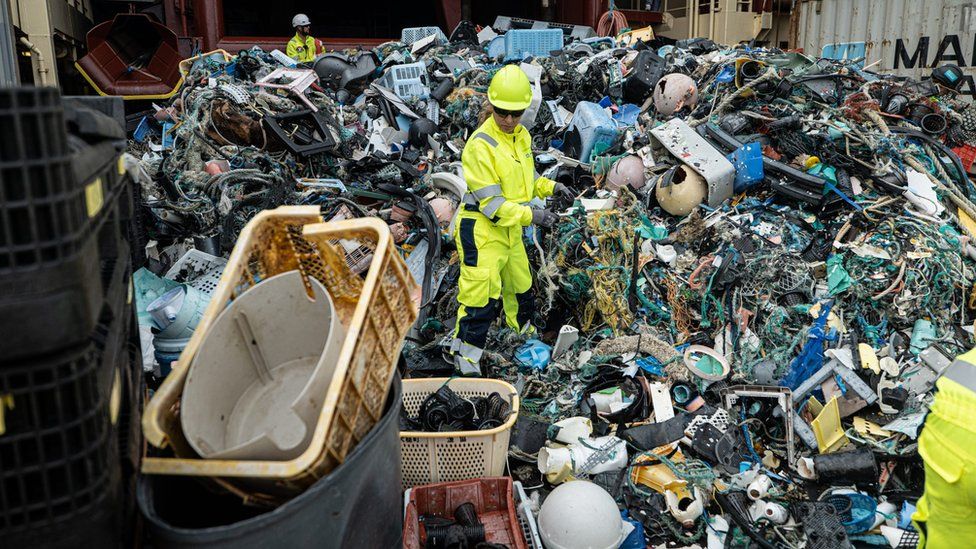 The Ocean Cleanup crew sorts through plastic on a ship deck after an extraction