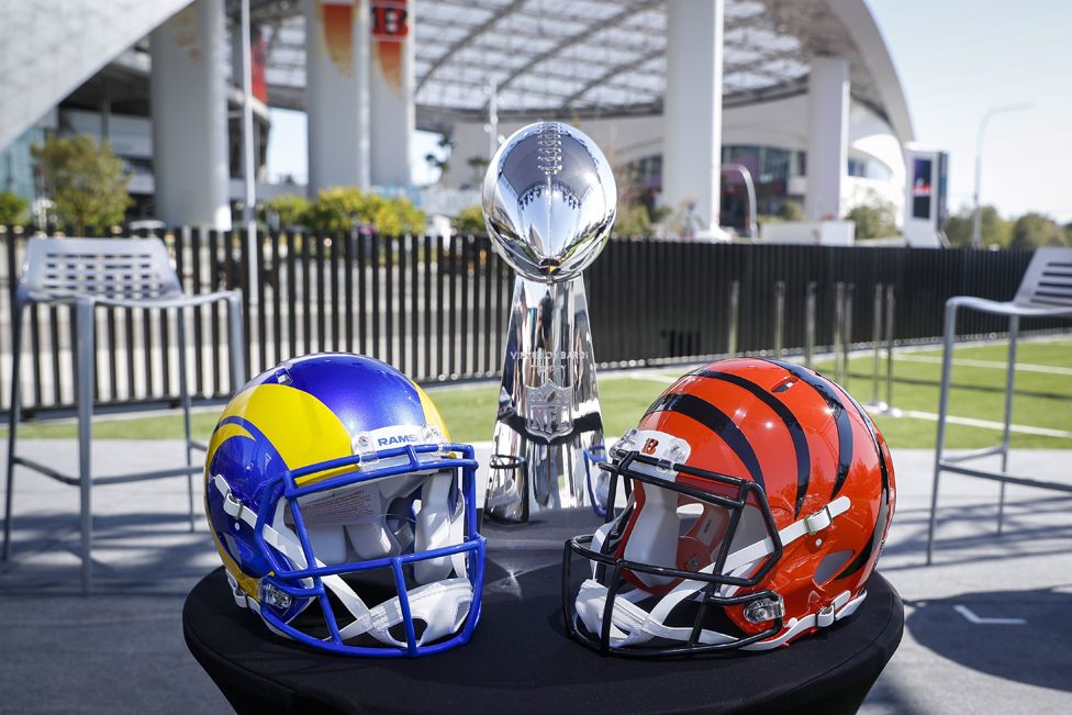 Rams and Bengals helmets next to the Vince Lombardi trophy, outside Super Bowl venue the SoFi Stadium, in Los Angeles