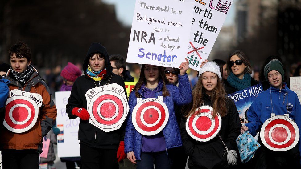 Students from Centreville, Virginia wear targets on their chests as they arrive for the March for Our Lives rally in Washington DC, 24 March 2018
