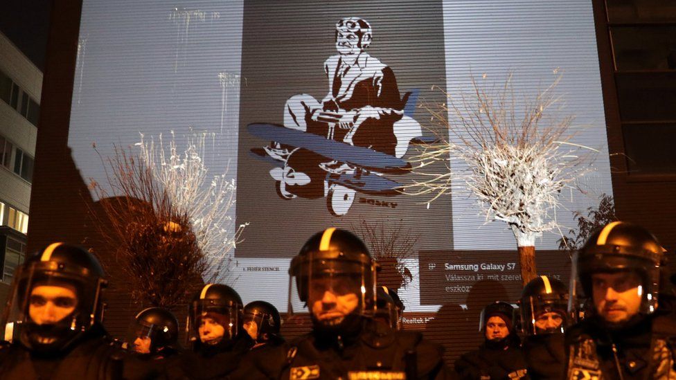 Humorous images of Viktor Orban were projected on the wall of the state TV building
