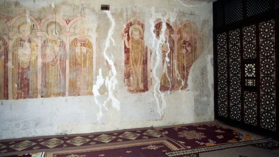 A view of the inside of the Monastery Of Saint Macarius The Great, featuring faded frescoes
