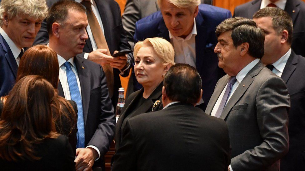 Romanian Prime Minister Viorica Dancila (C) is surrounded by members of her cabinet after the government was toppled by a no-confidence vote, 10 October 2019