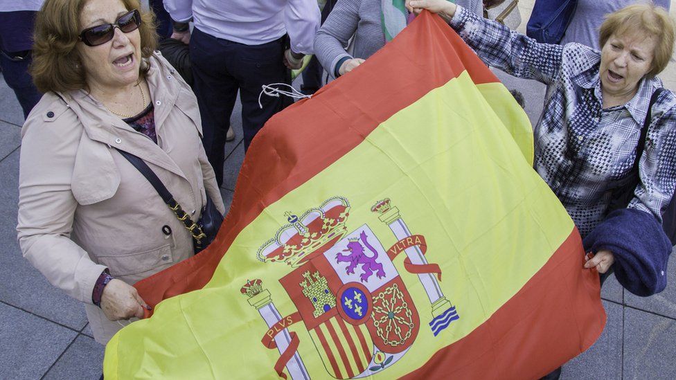 Protesters wave Spanish flag
