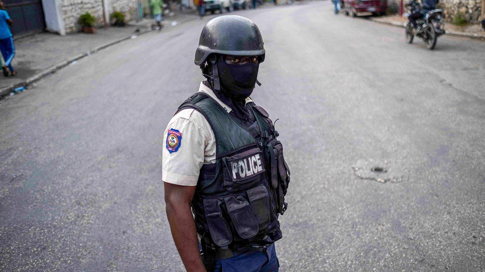 A Haitian police officer stands guard in Port-au-Prince