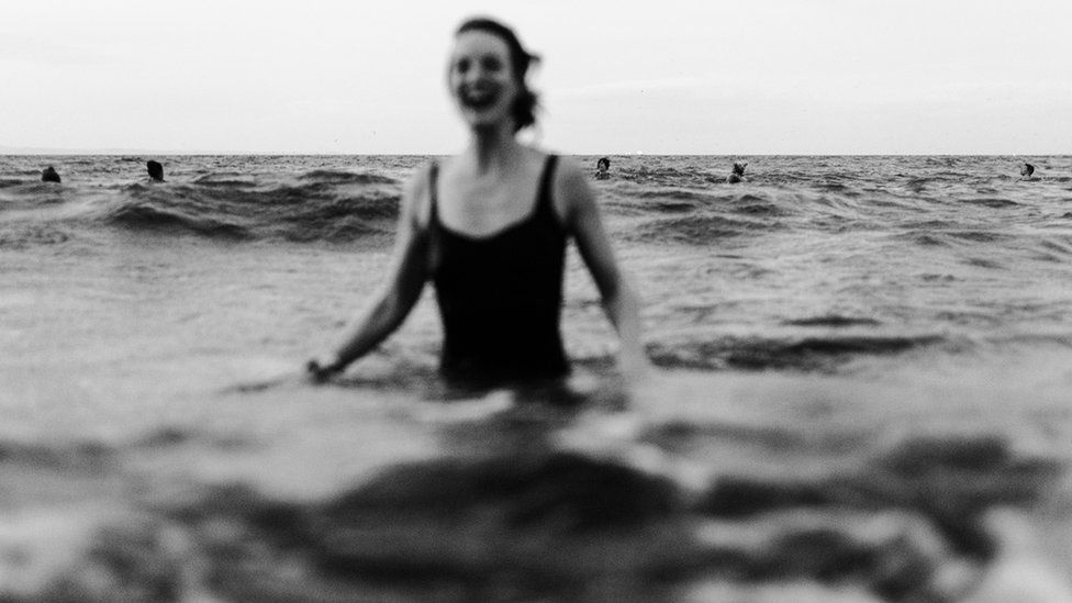 A smiling woman in the sea