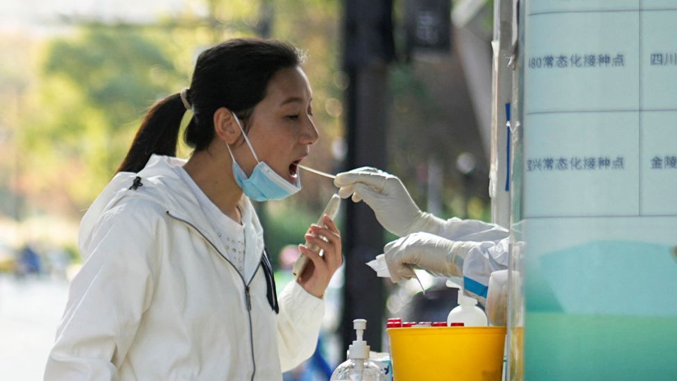 A woman gets tested at a testing site, following the Covid outbreak in Shanghai