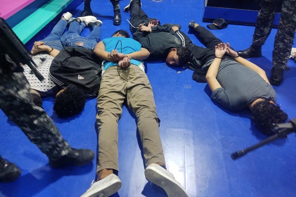 People accused of invading and taking over television station TC with weapons and forcing staff to lie and sit down, lie handcuffed on the floor in a police handout, in Guayaquil, Ecuador, January 9, 2024
