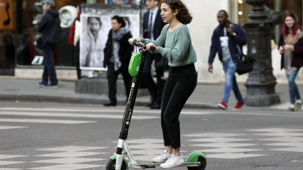 Woman riding an electric scooter in Paris