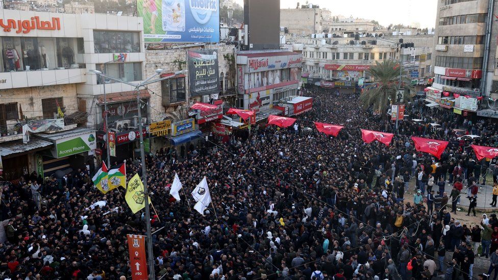 Mourners carry the bodies of Palestinians killed during an Israeli raid in Nablus, in the occupied West Bank, on 22 February 2023
