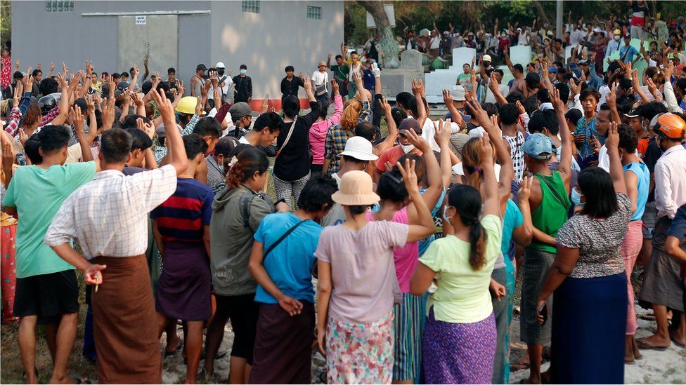Mourners gesture the three finger salute as they attend the funeral of Tin Hla, 43, who was shot dead by security forces during a protest against the military coup in Thanlyin township, outskirts of Yangon, Myanmar on March 27, 2021.