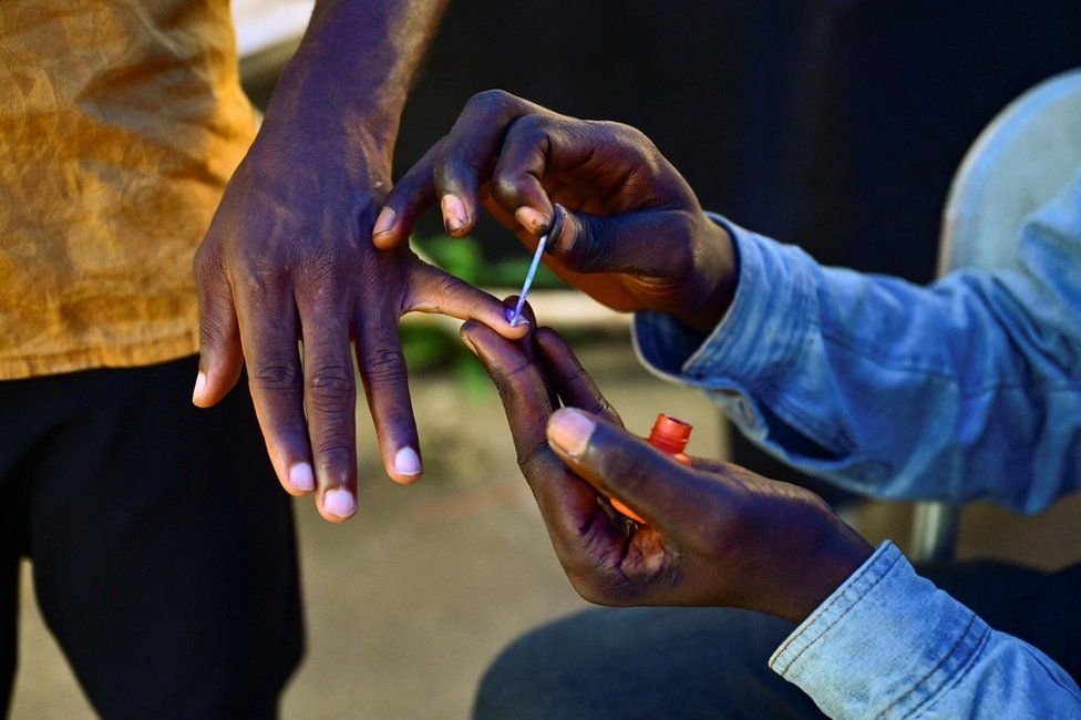 A voter gets his nail inked after casting his ballot for the national elections at a polling station in Freetown, Sierra Leone - Saturday 24 June 2023