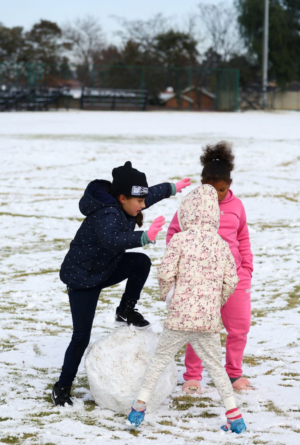 Girls play with a large snow ball at a school in Brackenhurst, south of Johannesburg, on 10 July.