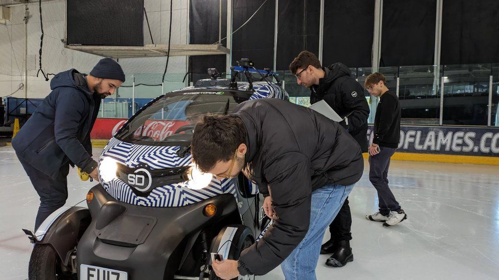University of Surrey researchers with driverless car on ice rink