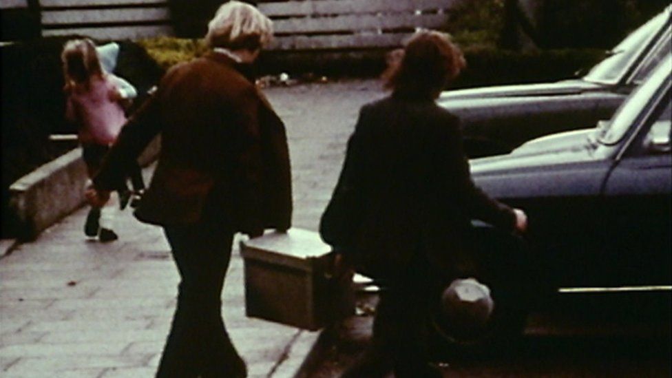Two men carrying the bomb used in the attack on the Queen's University sports hall