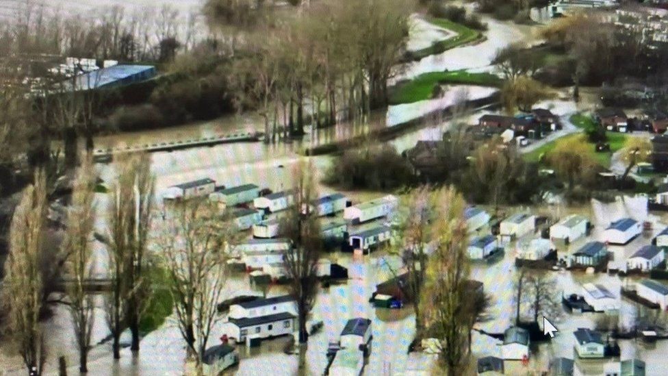 Mobile homes surrounded by water at a flooded holiday park