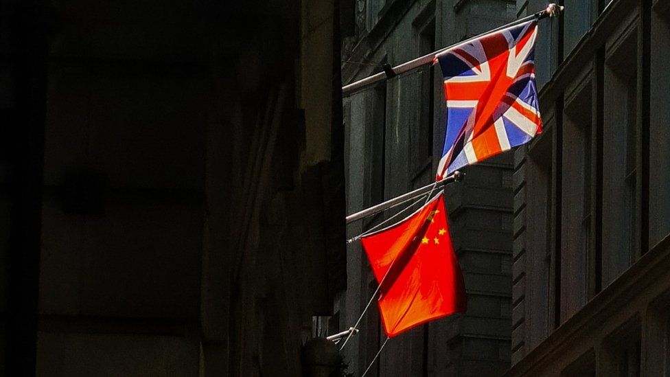 The Union flag and Chinese flag hang together in the City of London