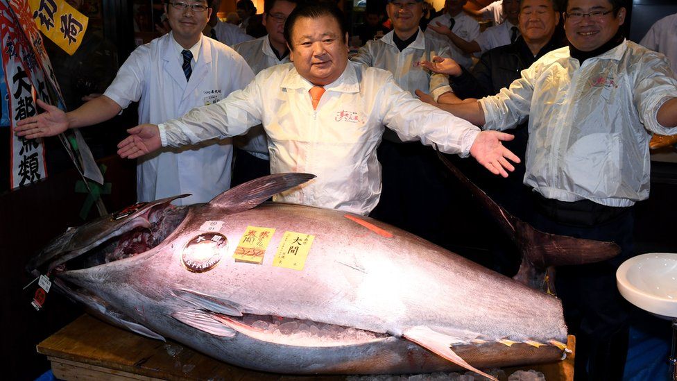 Kiyoshi Kimura, the president of sushi restaurant chain Sushi-Zanmai, poses with a 212-kilogram bluefin tuna at his main restaurant near the Tsukiji fish market in 2017